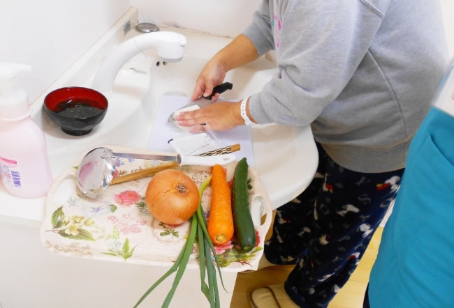 女性が日常生活動作である料理訓練を行っている